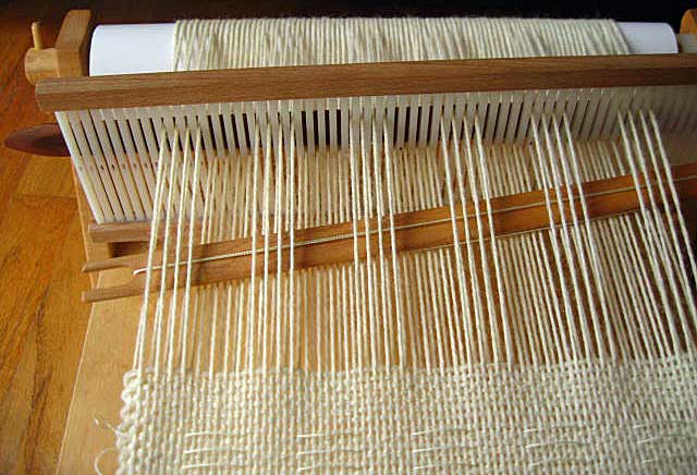 Put the rigid heddle in the neutral position. Bring the pickup stick forward 